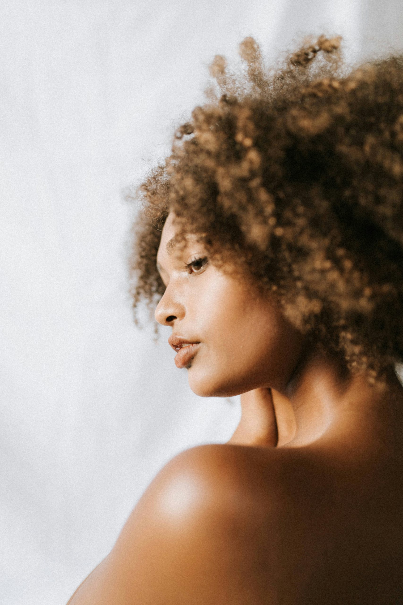 Image of a black woman with natural curly afro hair