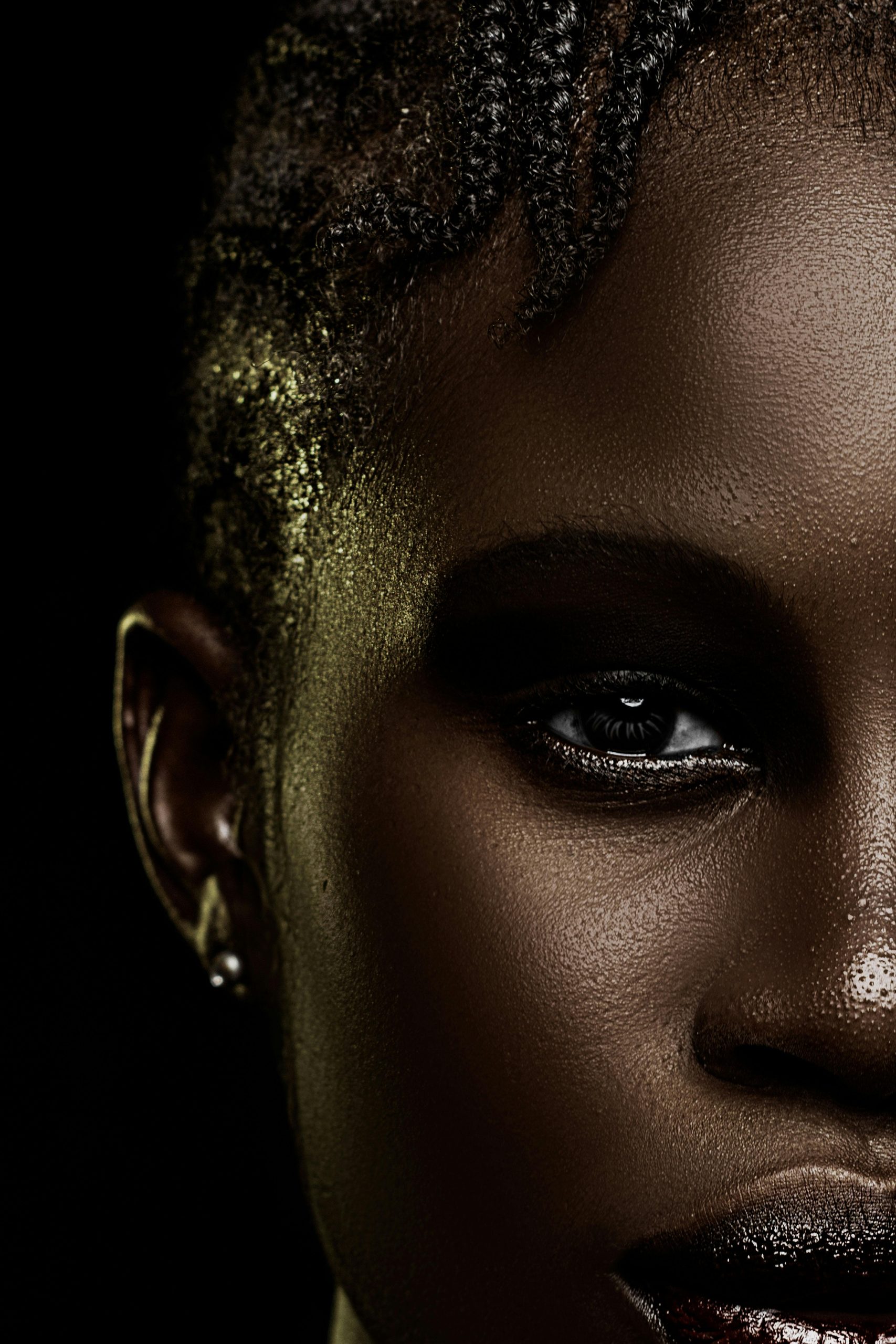 A close up editorial photo of a black woman with makeup