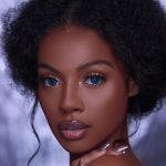 A black girl with doll like makeup