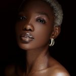 A black woman with natural makeup and a short haircut style