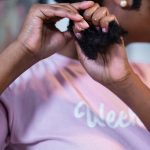 A black woman doing her hair