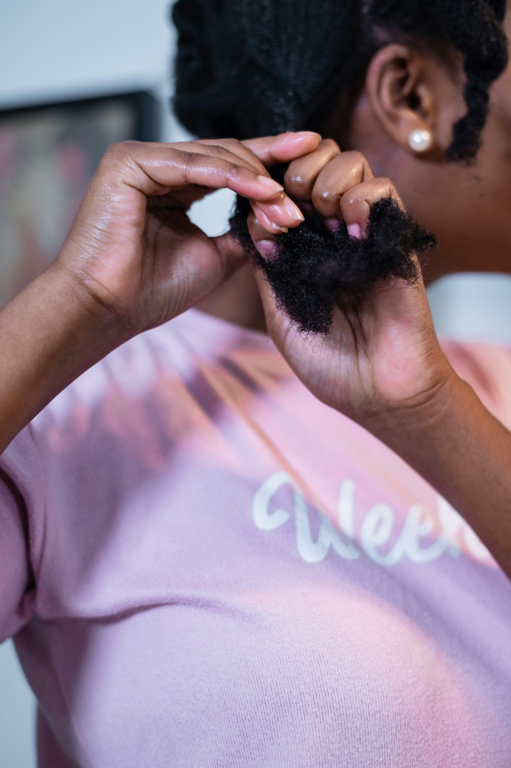 A black woman doing her hair
